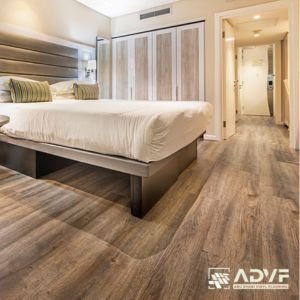 Modern hotel room with wood flooring.